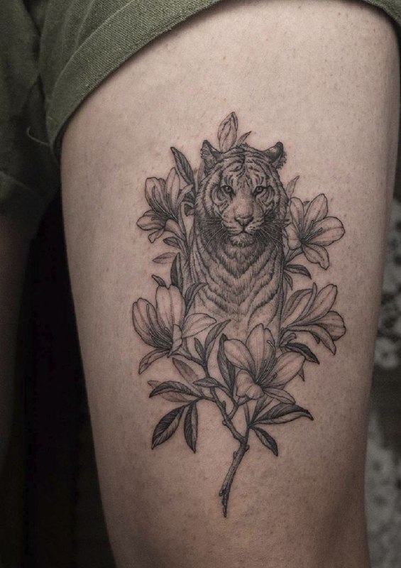 Tattoo of a tiger and flowers on the shoulder for men