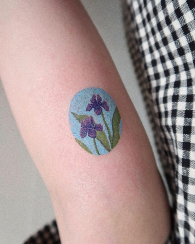 Color iris tattoo on the arm for women