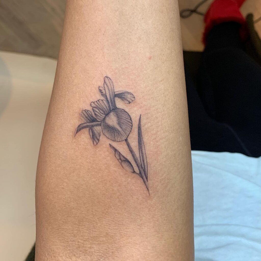 Iris tattoo on the forearm for women