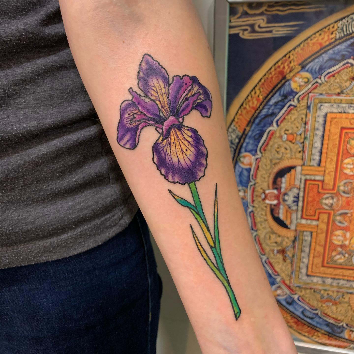 Color iris tattoo on the forearm for women