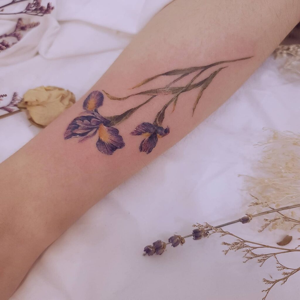 Color iris tattoo on the forearm for women