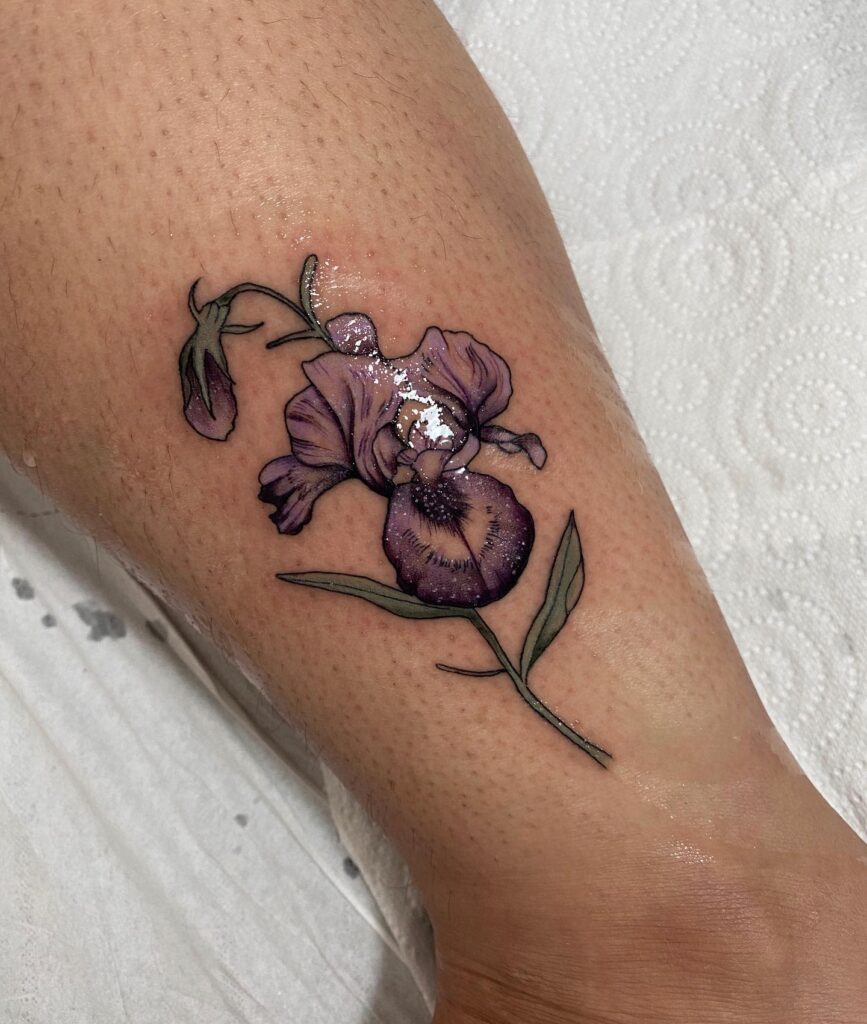 Color iris tattoo on the shin for women