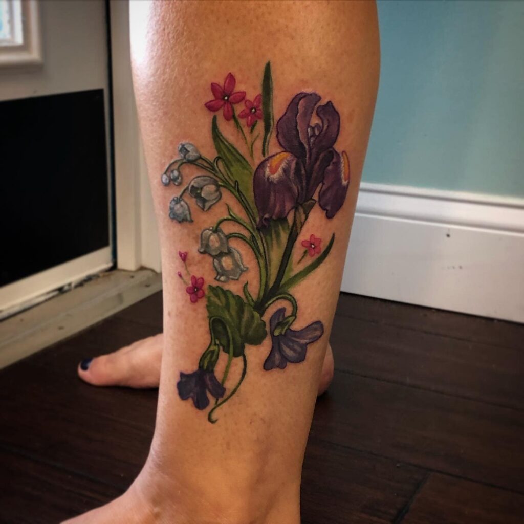 Color iris tattoo on the shin for women