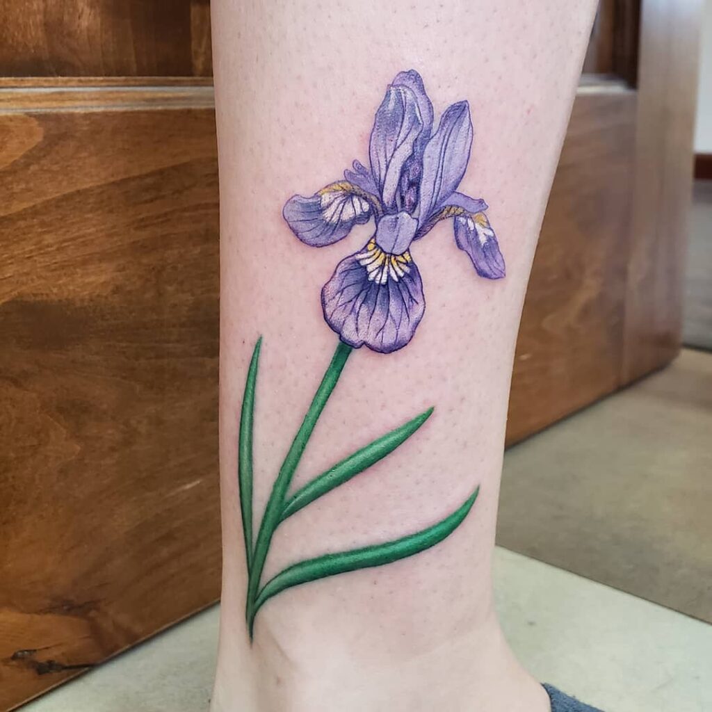 Color iris tattoo on the shin for women