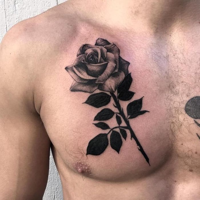 Large rose tattoo on the chest for men