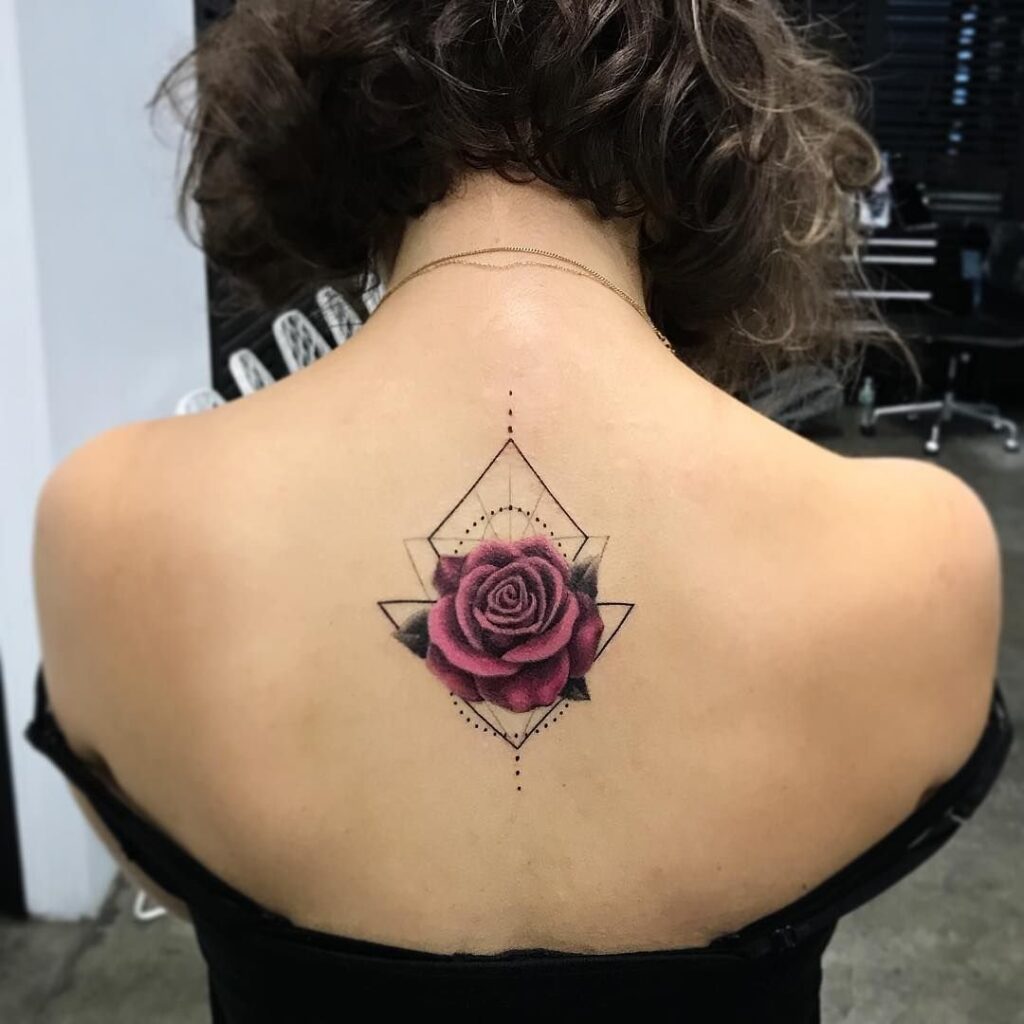 Colorful rose tattoo on the back for women