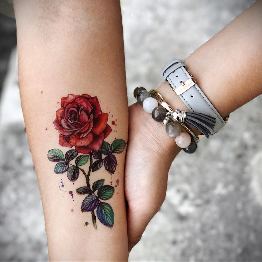 Colorful rose tattoo on the forearm for women