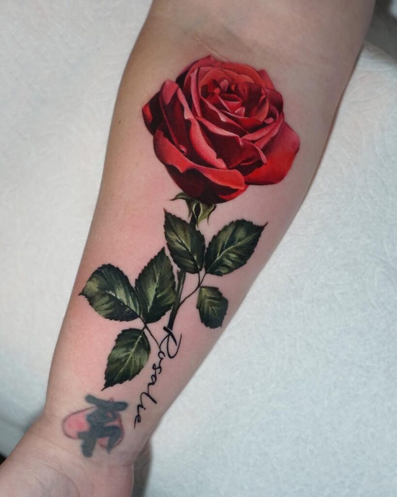 Color tattoo with an inscription on the forearm for women