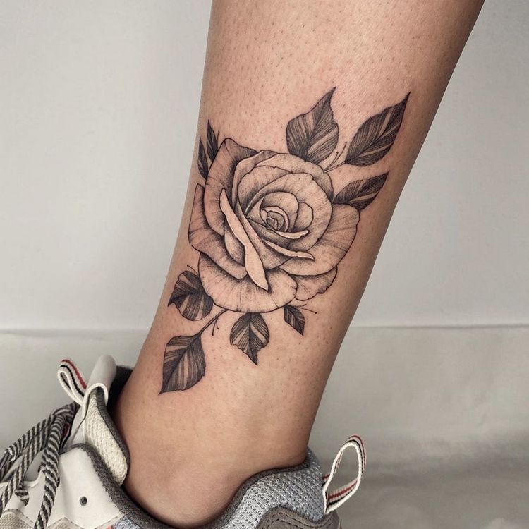 Rose tattoo on the shin for women