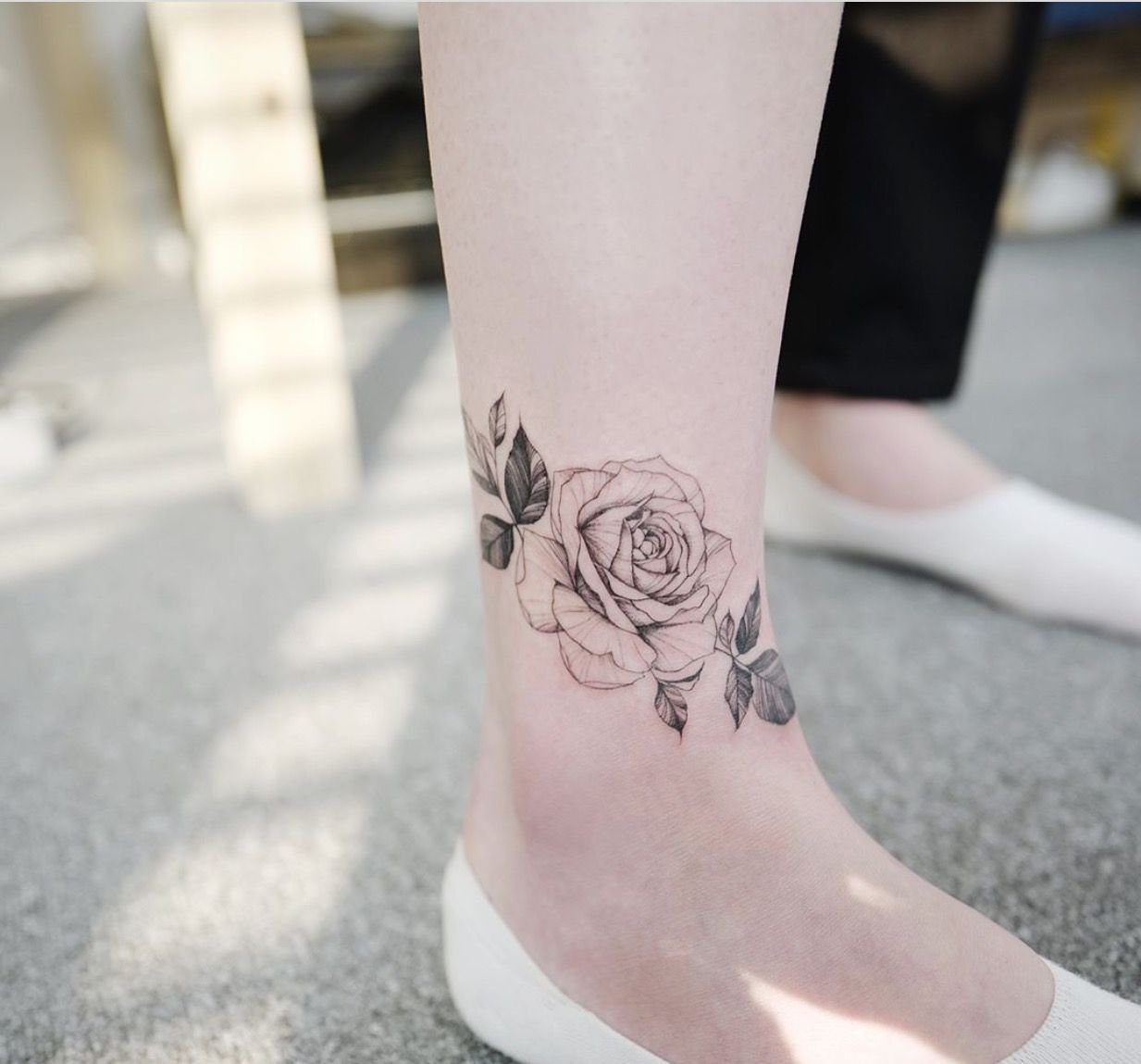 Rose tattoo on the shin for women