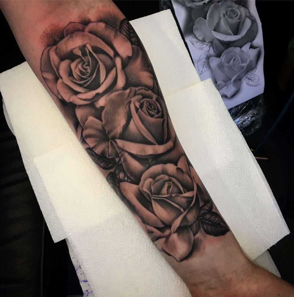 Tattoo of a rose on the forearm for men