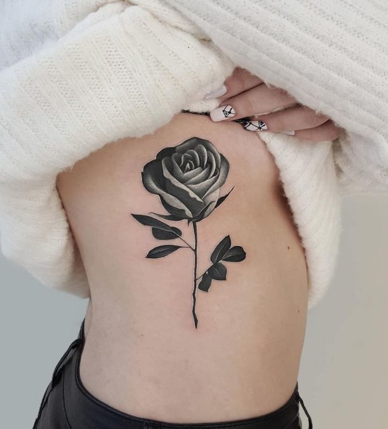 Large rose tattoo on the side for women