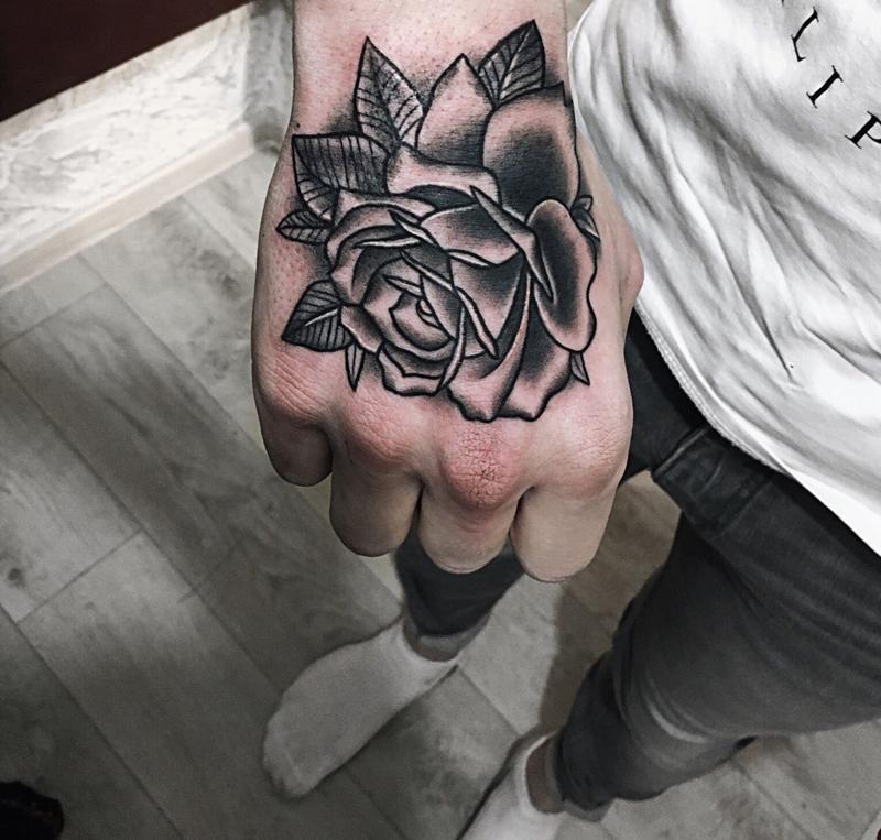 Rose tattoo on the hand for men