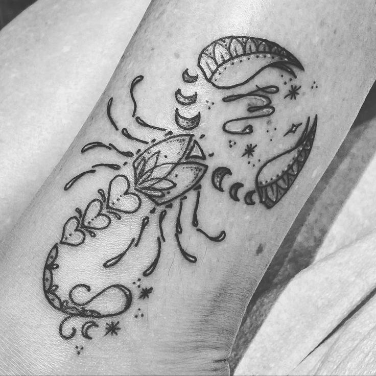 Tattoo of the zodiac sign of a scorpion on the leg for women