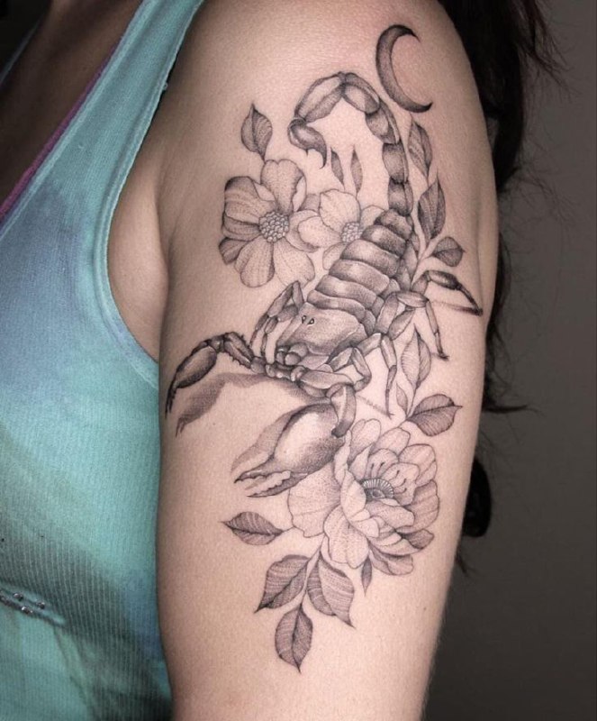 Tattoo of a scorpion on the shoulder for women