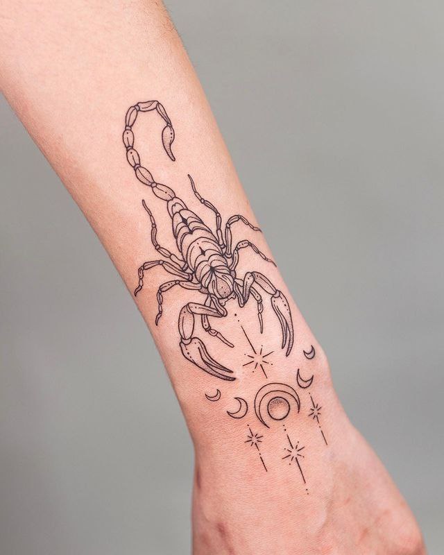 Tattoo of a scorpion on the forearm for women