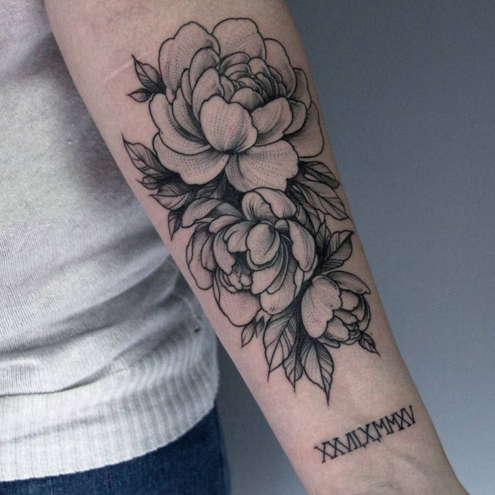 Large peony tattoo on the forearm for women