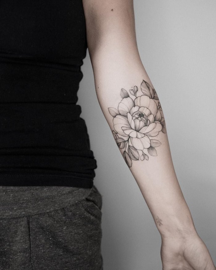 Peony tattoo on the forearm for women