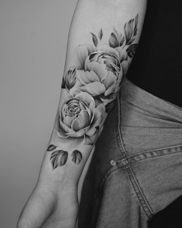 Peony tattoo on the forearm for women