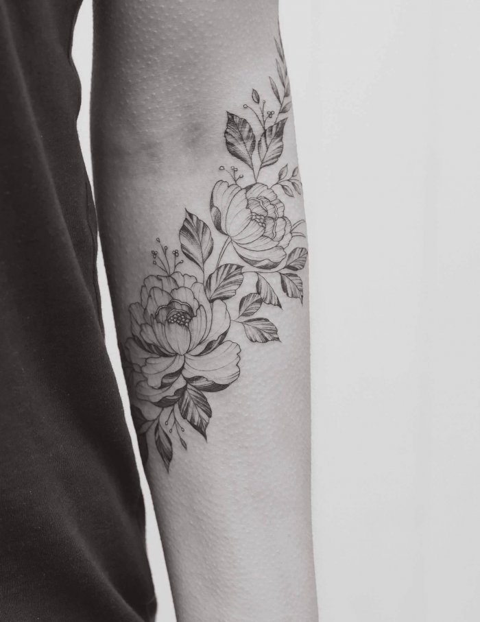 Peony tattoo on the forearm for women