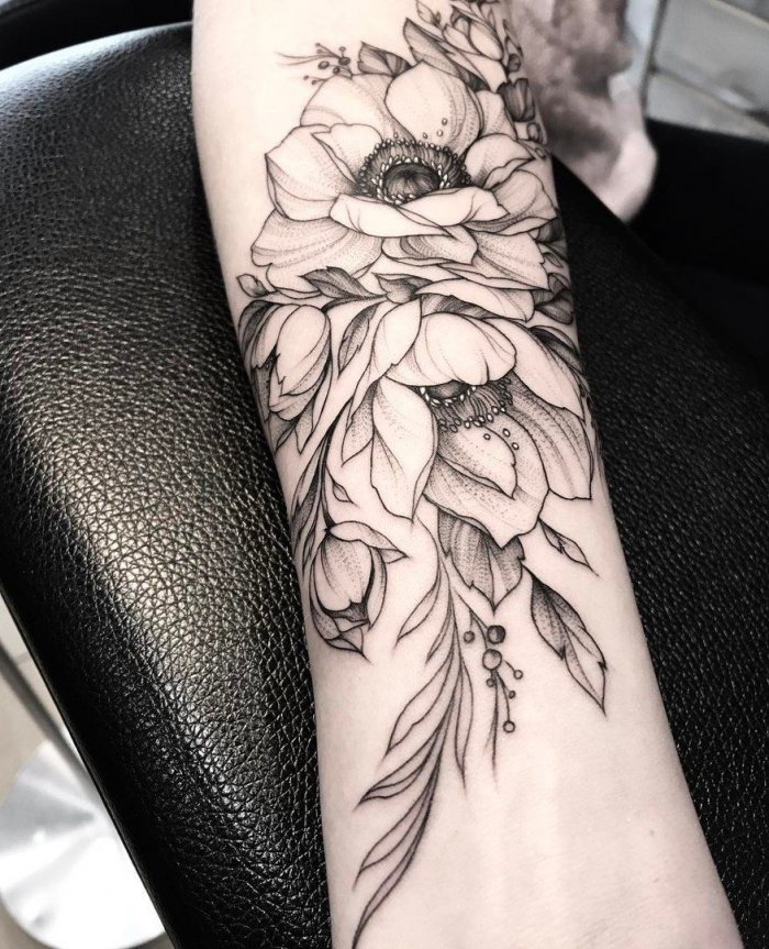 Large peony tattoo on the arm for women