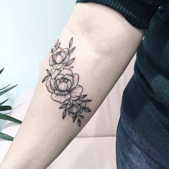 Peony tattoo on the forearm for women