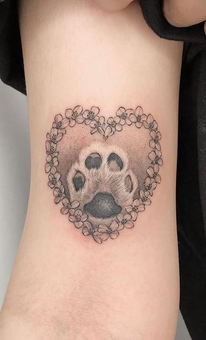 Dog paw tattoo on the shoulder for women