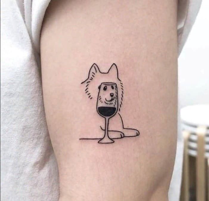 Tattoo of a dog and a glass of wine on the shoulder for women