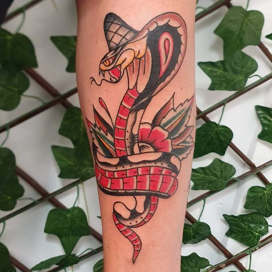 Tattoo of a colored cobra on a calf for women