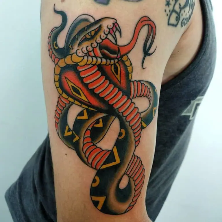 Tattoo of a colored cobra on the shoulder for men