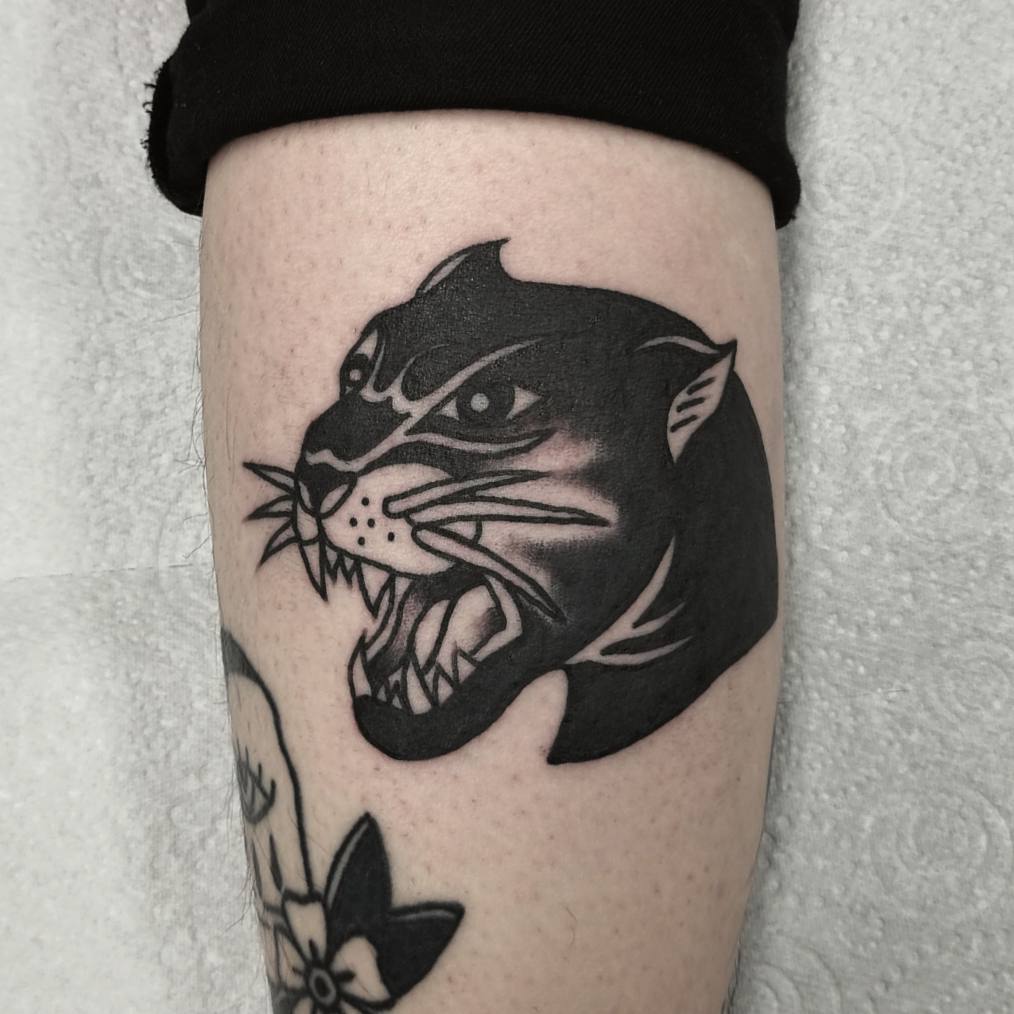 Puma tattoo on the shin for men