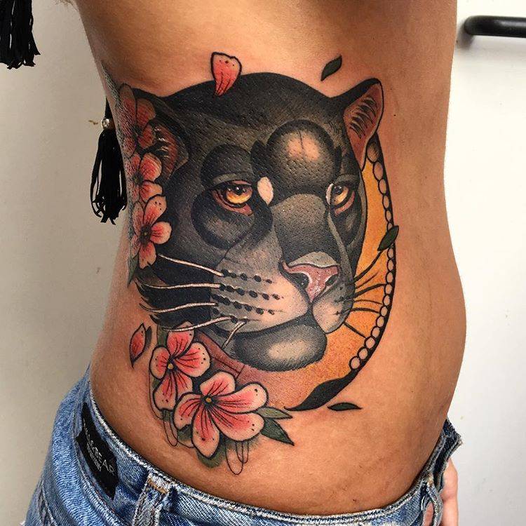 Puma tattoo on the side for women