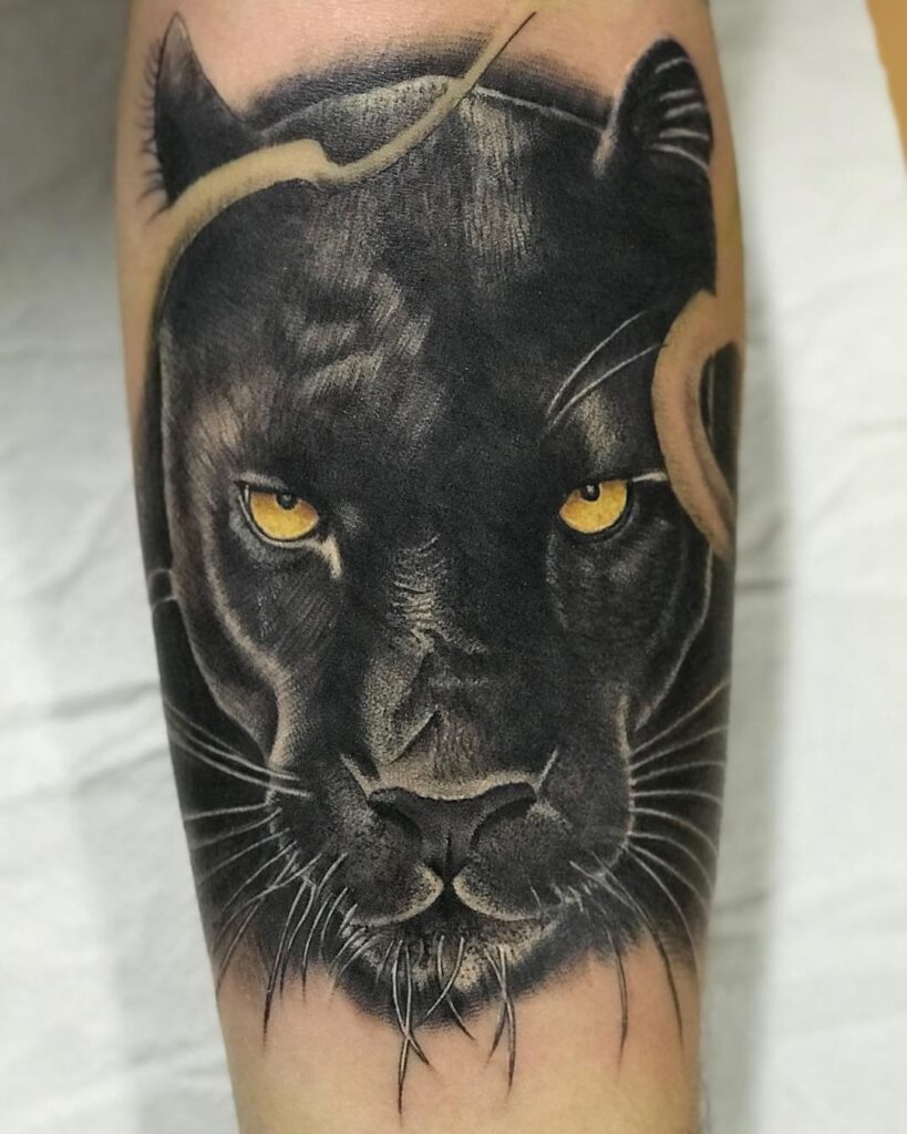 Puma tattoo on the shin for men