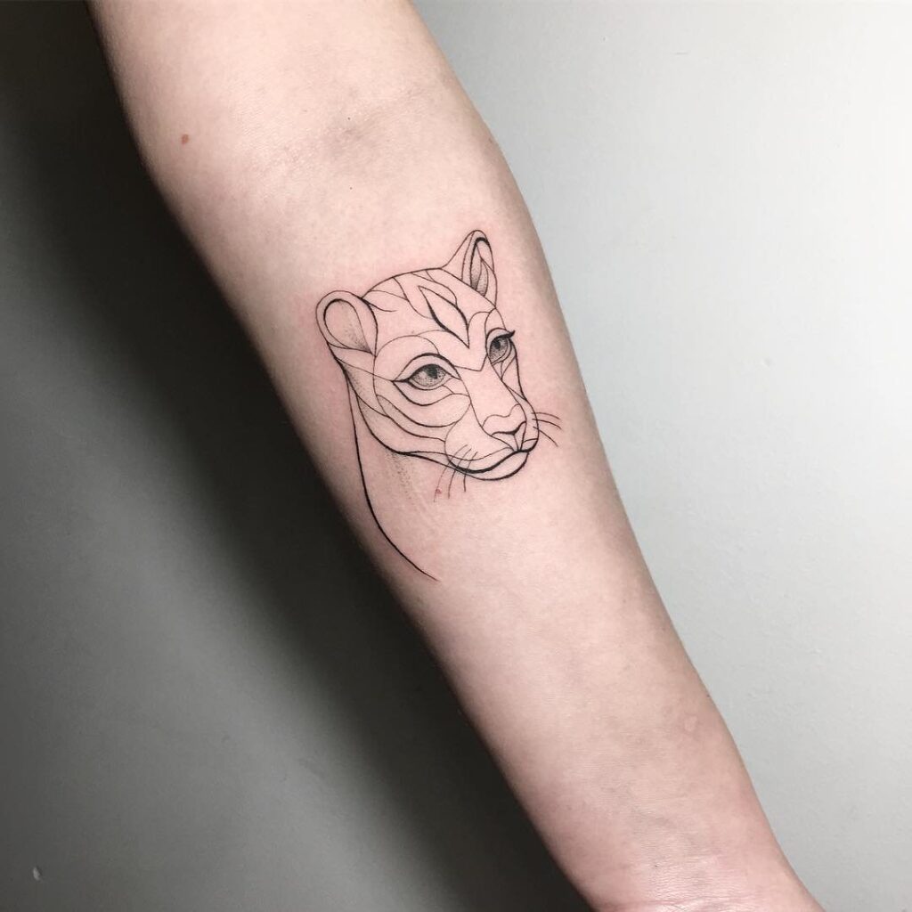 Puma tattoo on the forearm for women