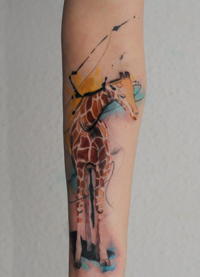 Color tattoo of a giraffe on the forearm for women