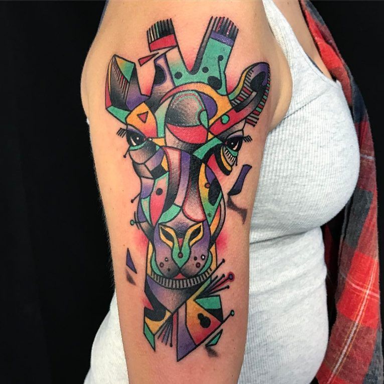 Color tattoo of a giraffe on the shoulder for women