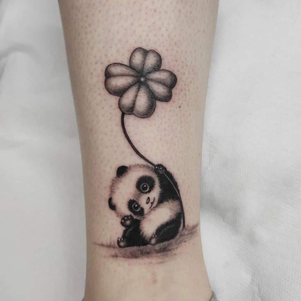 Panda tattoo on the shin for women