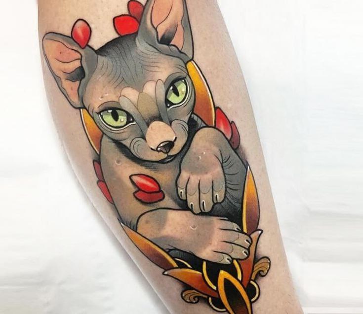 Tattoo of a colored sphinx on the leg for women