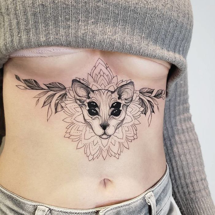 Tattoo of a sphinx on the stomach for women