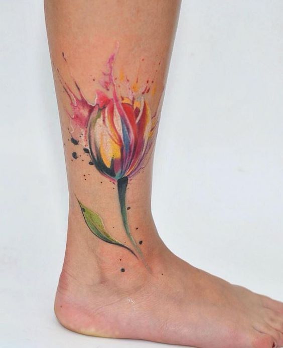 Colored tulip tattoo on the shin for men