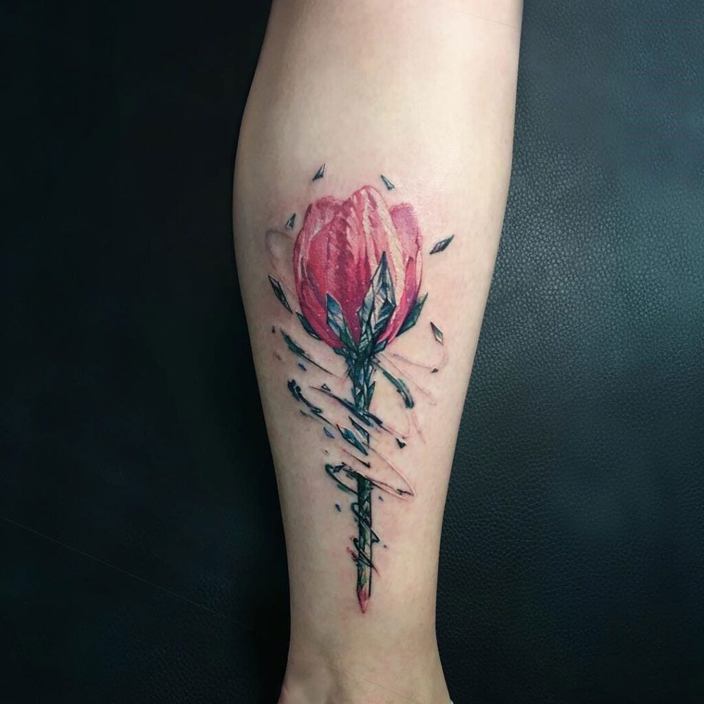 Color tattoo of a tulip on a calf for men