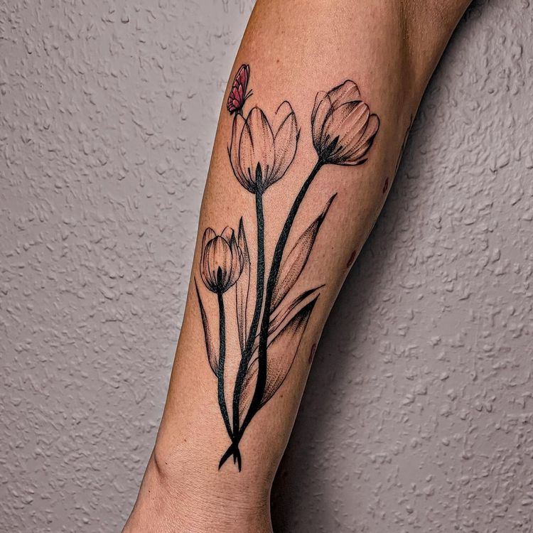 Large tulip tattoo with a butterfly on the forearm for men