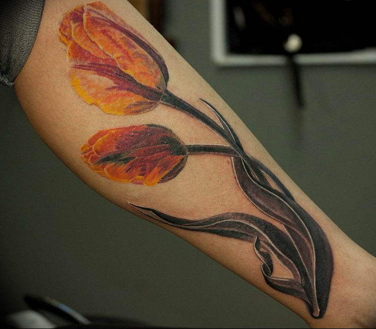 Large tulip tattoo on the arm for men