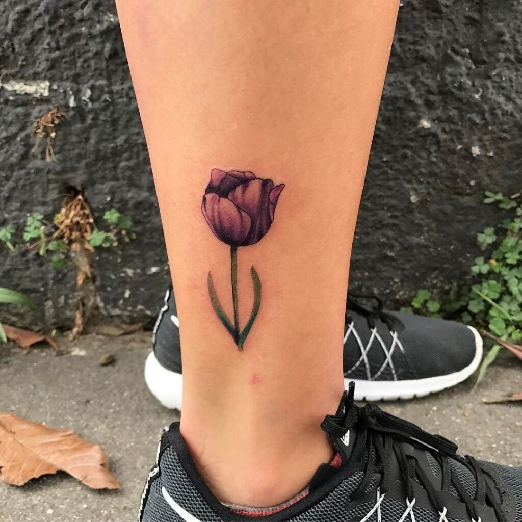 Colored tulip tattoo on the shin for women