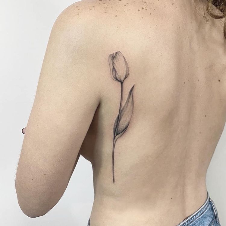 Tulip tattoo on the back for women