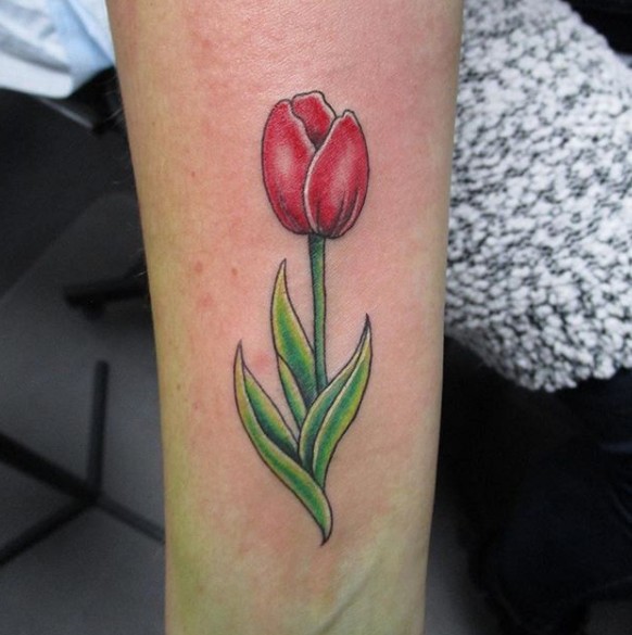 Color tattoo of a tulip on the forearm for women