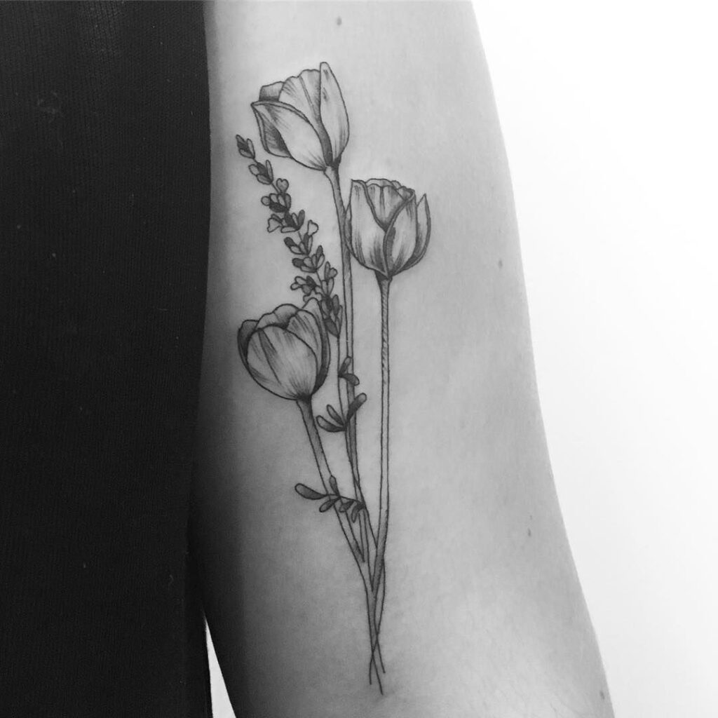 Large tulip tattoo on the shoulder for women