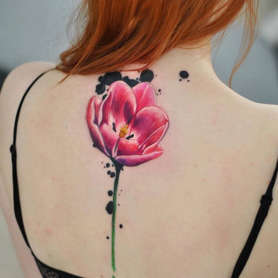 Large tulip tattoo on the back for women