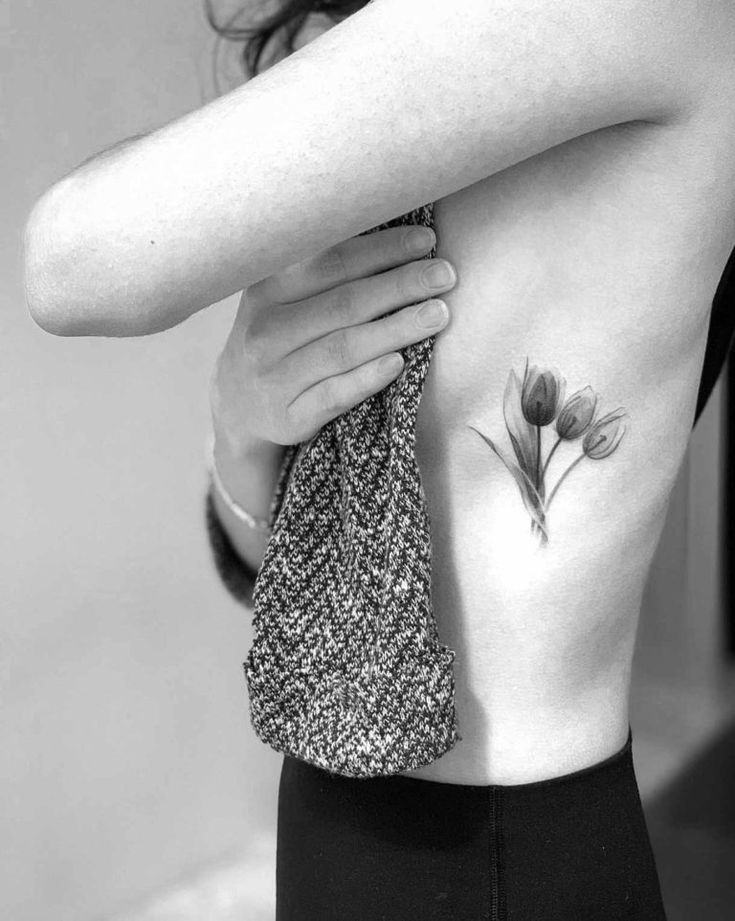 Tulip tattoo on the side for women