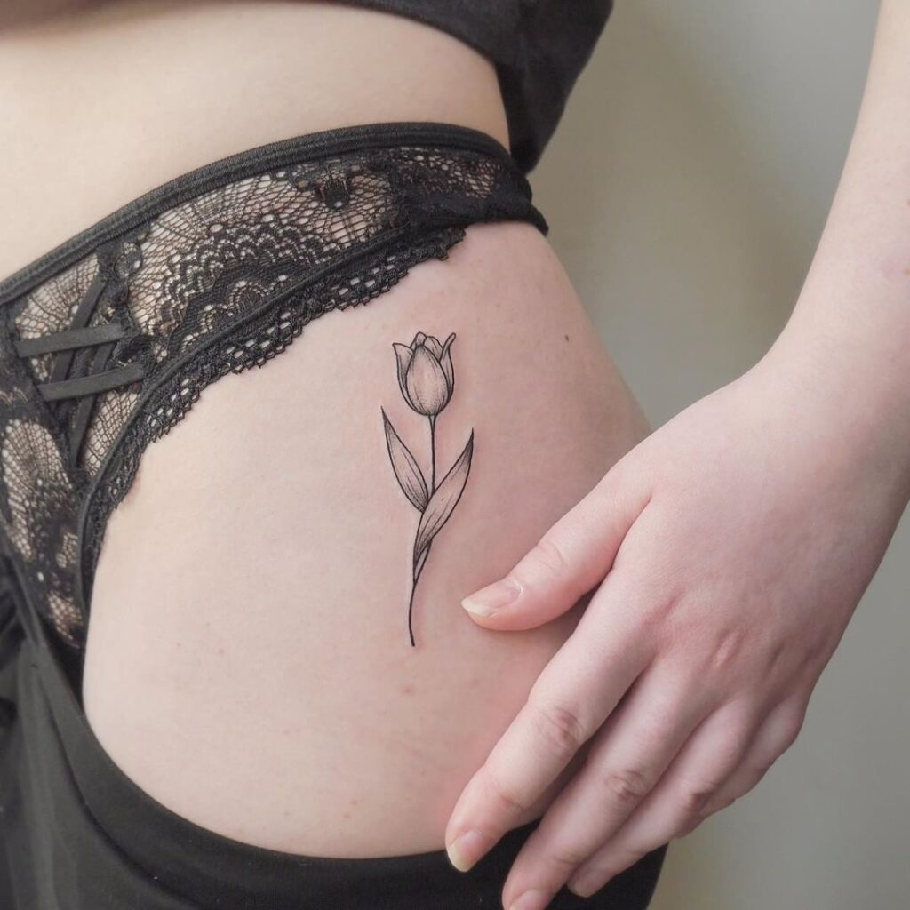 Tulip tattoo on the hip for women